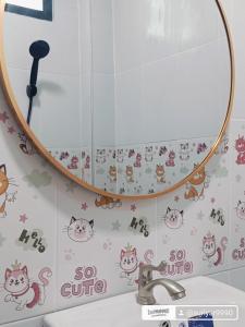a bathroom mirror with cats on the wall at ธารารักเลย ภูกระดึง in Ban Huai Som +10 photos