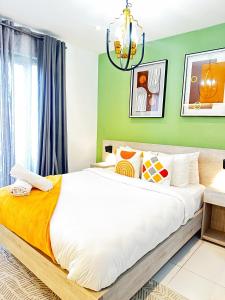 阿克拉Loxwood house by serenity homes的一间卧室设有一张带绿色墙壁的大床 更多17张照片