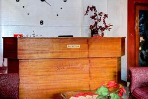 a wooden podium with a clock on the wall at OYO 90268 Aliyah Syariah in Jakarta