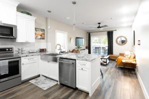 a kitchen with white cabinets and a counter top at Hip Gruene Condo, Walk to Gruene Hall, On River! in New Braunfels