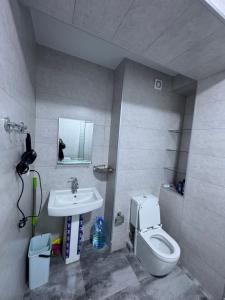 a bathroom with a toilet and a sink at monolit residens 6C blok in Tbilisi City