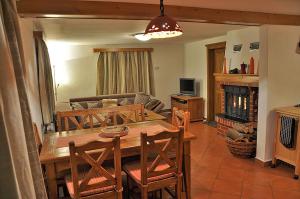 a living room with a wooden table and a couch at Apartment Rogla Lodge in Zreče +28 photos