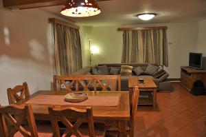 a living room with a table and a couch at Apartment Rogla Lodge in Zreče