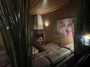 a room with a bed with a fireplace in it at Chalet BERGliebe Willingen- Nähe Skywalk in Willingen