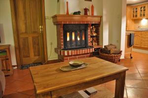 a living room with a table and a fireplace at Apartment Rogla Lodge in Zreče
