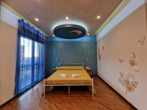 a bedroom with a bed and a large window at Moonlight Apartment in Fiumicino