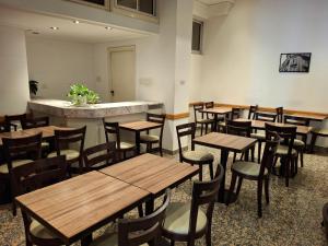a dining room with wooden tables and chairs at Novel Hotel in Buenos Aires