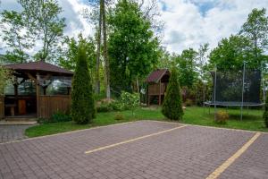 a garden with a basketball hoop and a playground at Gościniec Lila in Mikołajki +6 photos
