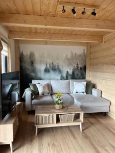 a living room with a couch and a table at Domek Sumigoj w Chochołowie in Chochołów