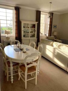un soggiorno con un tavolo e un divano di 2 bedroom Townhouse within Grade C listed Ladysbridge House a Ladysbridge Station
