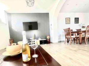 a bottle of wine sitting on a table in a living room at Apartment Lucija - Dekani in Dekani