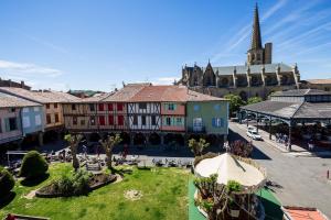 an aerial view of a town with a church at APPARTEMENT F3 BOX Vélo Moto Centre historique in Mirepoix