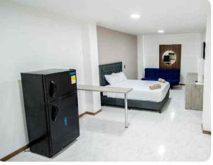 a bedroom with a bed and a desk in it at Hotel Boutique Casa Teresita in Medellín +35 photos