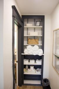 a cabinet filled with white towels in a room at 5 Minutes to the Falls-Luxury Home 3BR 2 Bath - USA Side in Niagara Falls