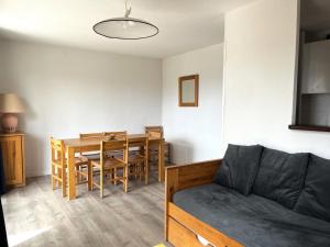 a living room with a couch and a dining room table at Résidence Balcons Du Soleil 1 - T3/8pers BALCONS DU SOLEIL 30-Peyresourde MAE-4644 in Germ