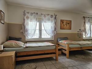 two beds in a room with a window at 01 Manuela in Ober-Mörlen