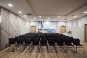 a room with a large room with chairs in it at Hotel Zatoka in Gdańsk