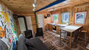 a kitchen with a table and a stove in a room at Domek na Czapli in Morzyczyn