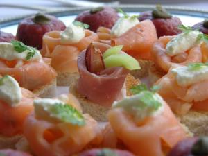 a plate of food with tomatoes and fruit on bread at Pfeifles Höhenhotel in Baiersbronn
