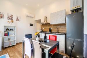 a kitchen with a table and a refrigerator at Da Vinci B&B in Florence