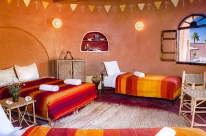 Postel nebo postele na pokoji v ubytování Ecolodge La Palmeraie