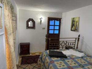 a bedroom with a bed and a window at The Medina Riad in Tangier