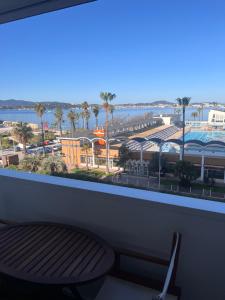 a balcony with a view of a city and the ocean at La Girelle vue mer proche plage in Toulon