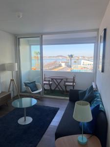 a living room with a couch and a view of the ocean at La Girelle vue mer proche plage in Toulon