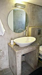 a bathroom with a sink and a mirror at Charming Bright & Airy Loft Studio! in Ierápetra +13 photos