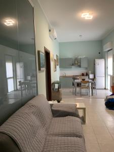 a living room with a couch and a kitchen at Seregno Dolce Vita in Seregno