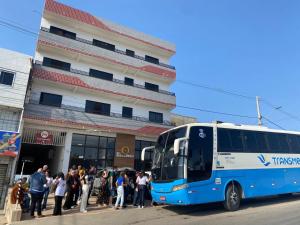 a group of people standing in front of a bus at Hotel Rota do Sertão in Serra Talhada