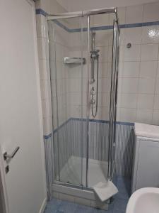 a shower with a glass door in a bathroom at Fleming hill apartments - Free Private Parking & Garden in Rome +12 photos