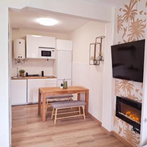 a small kitchen with a table and a fireplace at Apartamento en el centro recién reformado in Santander