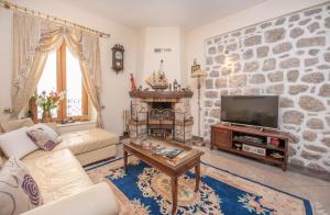 a living room with a stone wall at S&P City Center Apartments in Kotor