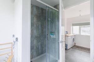 a bathroom with a shower with a glass door at Sea Breeze in Brading +68 photos
