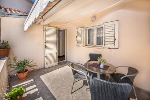 a small balcony with a table and chairs at S&P City Center Apartments in Kotor