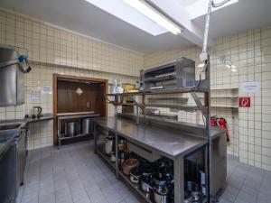 a kitchen with a counter with pots and pans at Eifel Nationalpark Grand Lodge in Schleiden