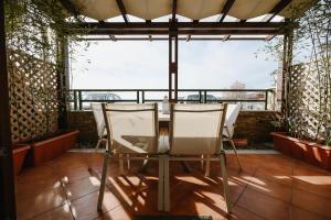 two chairs and a table in a room with a window at Serenity in Agria