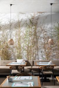 a restaurant with tables and chairs and a view of the ocean at Rigas Boutique Hotel & Spa in Afitos