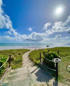 a path to the beach with the ocean in the background at Baía Branca Beach Resort in Tamandaré