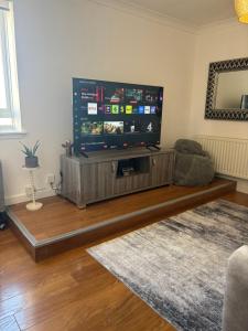 a living room with a large flat screen tv at Saltayr in Ayr +21 photos