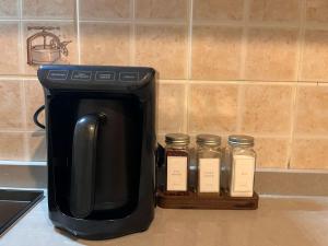 a coffee pot and five jars on a kitchen counter at DALAMAN 2 ODALI DAİRE in Dalaman