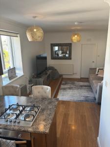 a kitchen and living room with a stove top at Saltayr in Ayr