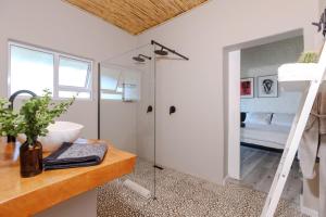 a bathroom with a tub and a sink and a shower at Enso Botanico Boutique Villa, Kosmos in Hartbeespoort
