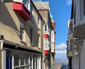 a row of buildings on a street next to the ocean at Beachway, Cromer in Cromer