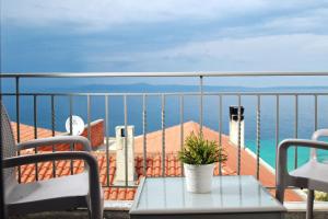 a balcony with a table and a view of the ocean at Rigas Boutique Hotel & Spa in Afitos