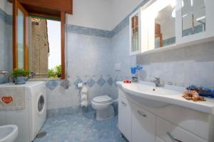 a bathroom with a sink and a toilet and a mirror at Casa Ersilia in Agerola +17 photos
