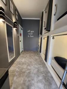 a hallway of a tiny house with a room with a couch at Vila Rock Hostel - próximo Allianz Parque, Vila Madalena, Av Paulista, Hospital das Clínicas INCOR FMUSP in São Paulo