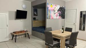 a dining room with a table and a bed at Appartamento Vacanze - Holiday Apartment "Ortamore" in Orta San Giulio