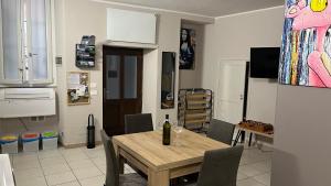 a kitchen with a table and a dining room at Appartamento Vacanze - Holiday Apartment "Ortamore" in Orta San Giulio